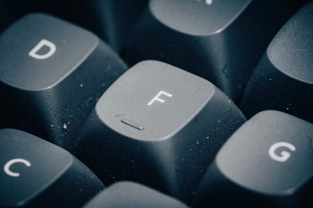 Close-up of dust and specks on dark mechanical keyboard keycaps