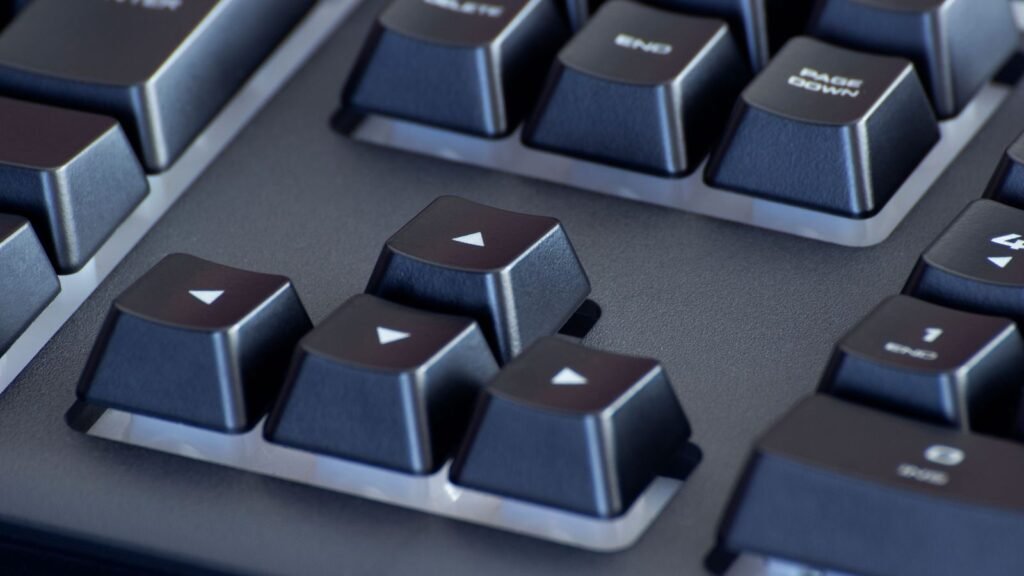 Close-up of black keycaps on a mechanical keyboard showing arrow keys, End and Page Down